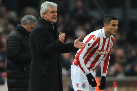 Stoke City manager Mark Hughes, left, and Stokes Ibrahim Afellay during the English Premier League soccer match between Stoke City and Manchester United at the Britannia Stadium, Stoke on Trent, England, Saturday, Jan. 21, 2017. (AP Photo/Rui Vieira)
