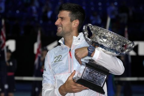 Novak Djokovic of Serbia reacts as he holds the Norman Brookes Challenge Cup after defeating Stefanos Tsitsipas of Greece in the men's singles final at the Australian Open tennis championship in Melbourne, Australia, Sunday, Jan. 29, 2023. (AP Photo/Aaron Favila)