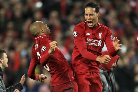 Liverpool's Fabinho, left, and Virgil van Dijk celebrate after the Champions League Semi Final, second leg soccer match between Liverpool and Barcelona at Anfield, Liverpool, England, Tuesday, May 7, 2019. Liverpool won the match 4-0 to overturn a three-goal deficit to win 4-3 on aggregate. (Peter Byrne/PA via AP)