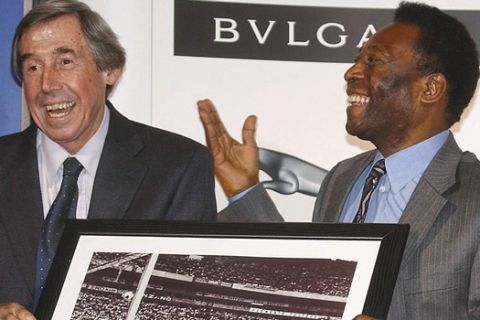 FILE - In this Thursday March 4, 2004 file photo Brazilian soccer legend Pele, right, presents former England goalkeeper Gordon Banks with a photograph showing Banks saving a header from Pele in the 1970 World Cup, at a press conference in London, to mark FIFA's 100 year anniversary. English soccer club Stoke said Tuesday Feb. 12, 2019 that World Cup-winning England goalkeeper Gordon Banks has died at 81. (AP Photo/Max Nash, File)