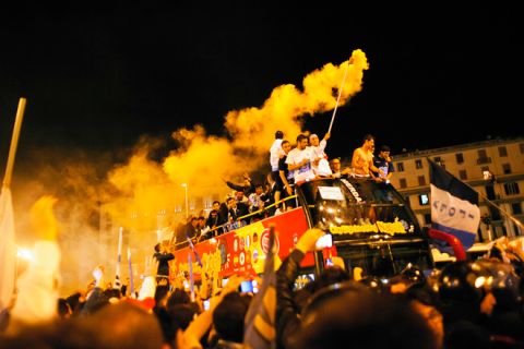 Napoli's football players ride on a double bus as their fans celebrate their victory against Juventus in Naples on May 21, 2012. S.S.C. Juventus' record-breaking 43-match undefeated run came to an end when Napoli won the Italian Cup 2-0.  AFP PHOTO/ ANDREA BALDOANDREA BALDO/AFP/GettyImages