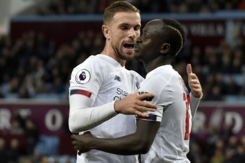 Liverpool's Sadio Mane, right, celebrates with Liverpool's Jordan Henderson after scoring his side's second goal during the English Premier League soccer match between Aston Villa and Liverpool at Villa Park in Birmingham, England, Saturday, Nov. 2, 2019. (AP Photo/Rui Vieira)