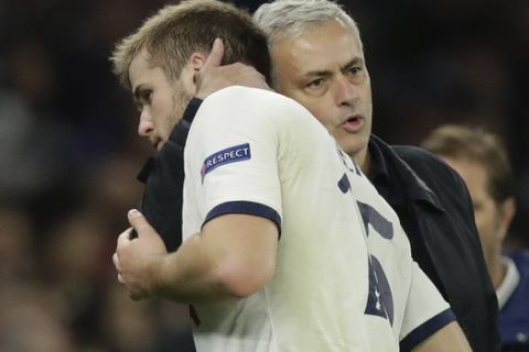 Tottenham's recently appointed head coach Jose Mourinho, in his second game in charge, embraces Eric Dier as he substitutes him off in a first half tactical change when they were losing 2-0, during the Champions League Group B soccer match between Tottenham Hotspur and Olympiakos at the Tottenham Hotspur Stadium in London, Tuesday, Nov. 26, 2019. The most difficult moment of the game for me was not when Olympiakos scored the first or the second goal," Mourinho said. "The most difficult moment of the game for me was when I made the change in the first half. Hurt the player but hurt myself. Not easy for the player, but not also easy for myself." (AP Photo/Matt Dunham)