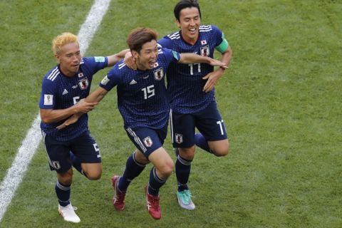 Japan's Yuya Osako, centre, celebrates after scoring his side's 2nd goal with teammates Makoto Hasebe, right, and Yuto Nagatomo, left, during the group H match between Colombia and Japan at the 2018 soccer World Cup in the Mordavia Arena in Saransk, Russia, Tuesday, June 19, 2018. (AP Photo/Vadim Ghirda)