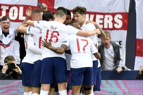 England's Marcus Rashford celebrates with his teammates after scoring his side's opening goal from penalty spot during the UEFA Nations League semifinal soccer match between Netherlands and England at the D. Afonso Henriques stadium in Guimaraes, Portugal, Thursday, June 6, 2019. (AP Photo/Martin Meissner)