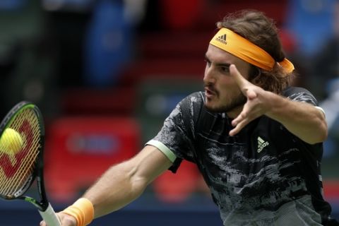 Stefanos Tsitsipas of Greec hits a return against Felix Auger-Aliassime of Canada during the men's singles match at the Shanghai Masters tennis tournament at Qizhong Forest Sports City Tennis Center in Shanghai, China, Wednesday, Oct. 9, 2019. (AP Photo/Andy Wong)