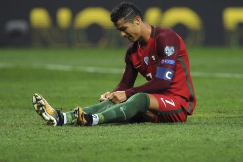 Portugal's Cristiano Ronaldo pulls up his socks during the World Cup Group B qualifying soccer match between Portugal and Faroe Islands at the Bessa Stadium in Porto, Portugal, Thursday Aug. 31, 2017. (AP Photo/Paulo Duarte)