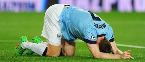BARCELONA, SPAIN - MARCH 18: James Milner of Manchester City falls to his knees during the UEFA Champions League Round of 16 second leg match between Barcelona and Manchester City at Camp Nou on March 18, 2015 in Barcelona, Spain.  (Photo by David Ramos/Getty Images)