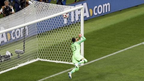 Croatia goalkeeper Danijel Subasic fails to stop a free kick from England's Kieran Trippier to open the score during the semifinal match between Croatia and England at the 2018 soccer World Cup in the Luzhniki Stadium in Moscow, Russia, Wednesday, July 11, 2018. (AP Photo/Thanassis Stavrakis)