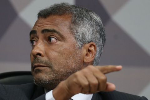Senator Romario Faria, a former Barcelona soccer star, attends a parliamentary commission investigating allegations of corruption in the Brazilian football confederation (CBF), at the Senate in Brasilia, Brazil, Wednesday, Dec. 16, 2015. An investigation by American and Swiss officials has snared the last three presidents of the CBF, all of whom have been indicted: Marco Polo del Nero and his predecessors Jose Maria Marin and Ricardo Teixeira. (AP Photo/Eraldo Peres)