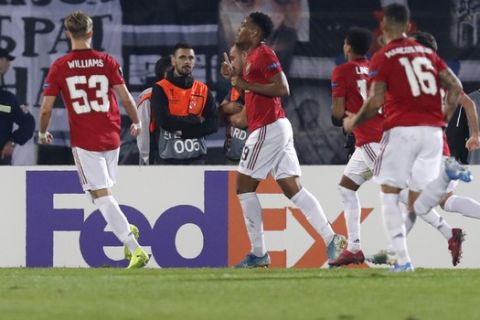 Manchester United's Anthony Martial, center, celebrates after scoring his side's first goal during the Europa League group L soccer match between Partizan Belgrade and Manchester United at the Partizan stadium in Belgrade, Serbia, Thursday, Oct. 24, 2019. (AP Photo/Darko Vojinovic)