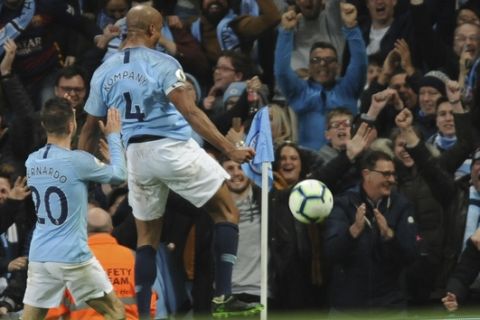 Manchester City's Vincent Kompany, right, celebrates after scoring his side's opening goal during the English Premier League soccer match between Manchester City and Leicester City at the Etihad stadium in Manchester, England, Monday, May 6, 2019. (AP Photo/Rui Vieira)
