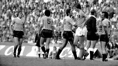 Uruguays defender Julio Montero Castillo, left, leaves the field after being sent off by the referee, who stands arguing with Uruguays defender Juan Masnik, right, during the World Cup football match between The Netherlands and Uruguay in Hanover, West Germany on June 15, 1974. At center is Hollands captain, forward Hendrik Johannes Cruijff "Johan Cruyff" and behind him, Uruguays Pedro Rocha. Holland went on to win the match 2-0. (AP Photo)