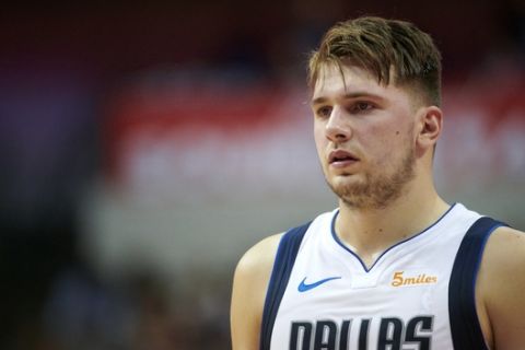 Dallas Mavericks guard Luka Doncic (77) looks on against the Beijing Ducks during the second half of an NBA exhibition basketball game Saturday, Sept. 29, 2018, in Dallas. (AP Photo/Cooper Neill)