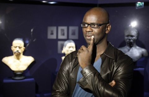 Former French international football player Lilian Thuram, ponders a question during an interview with the Associated Press, on the eve of the opening of a a new exhibition at the Quai Branly museum in Paris, Monday Nov. 28, 2011. Until less than a century ago, white people regularly put Africans, native Americans or Pacific islanders on display in circuses, expositions and shows. A new Paris exhibit, curated by former football star and anti-racism advocate Lilian Thuram, examines how this demeaning colonial-era tradition shaped attitudes that still linger today.(AP Photo/Remy de la Mauviniere)