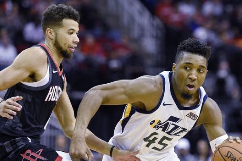 Utah Jazz guard Donovan Mitchell (45) dribbles as Houston Rockets guard Michael Carter-Williams defends during the second half of an NBA basketball game, Wednesday, Oct. 24, 2018, In Houston. Utah won 100-89. (AP Photo/Eric Christian Smith)