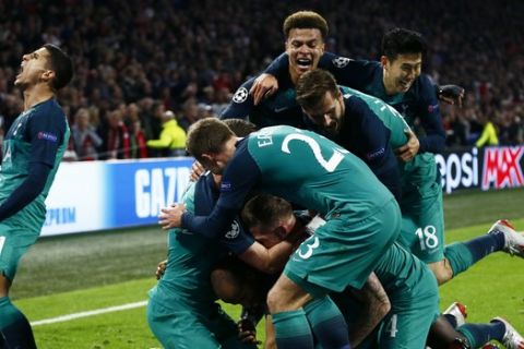 Tottenham players celebrate after scoring their third goal during the Champions League semifinal second leg soccer match between Ajax and Tottenham Hotspur at the Johan Cruyff ArenA in Amsterdam, Netherlands, Wednesday, May 8, 2019. (AP Photo/Peter Dejong)