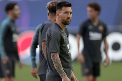 Barcelona's Lionel Messi stands on the pitch during a training session at the Luz stadium in Lisbon, Thursday Aug. 13, 2020. Barcelona will play Bayern Munich in a Champions League quarterfinals soccer match on Friday. (AP Photo/Manu Fernandez, Pool)
