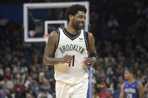 Brooklyn Nets guard Kyrie Irving (11) jogs up the court after scoring during the second half of an NBA basketball game against the Orlando Magic, Tuesday, March 15, 2022, in Orlando, Fla. (AP Photo/Phelan M. Ebenhack)