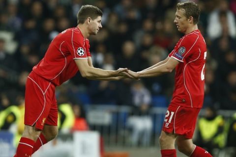 Liverpool's Steven Gerrard, left, replaces Lucas Leiva during a Group B Champions League soccer match between Real Madrid and Liverpool at the Santiago Bernabeu stadium in Madrid, Spain, Tuesday Nov. 4, 2014. (AP Photo/Andres Kudacki)