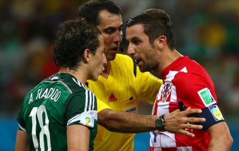 RECIFE, BRAZIL - JUNE 23:  Andres Guardado of Mexico and Darijo Srna of Croatia argue during the 2014 FIFA World Cup Brazil Group A match between Croatia and Mexico at Arena Pernambuco on June 23, 2014 in Recife, Brazil.  (Photo by Robert Cianflone/Getty Images)