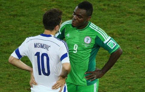CUIABA, BRAZIL - JUNE 21:  Zvjezdan Misimovic of Bosnia and Herzegovina and Emmanuel Emenike of Nigeria speak during the 2014 FIFA World Cup Group F match between Nigeria and Bosnia-Herzegovina at Arena Pantanal on June 21, 2014 in Cuiaba, Brazil.  (Photo by Clive Brunskill/Getty Images)