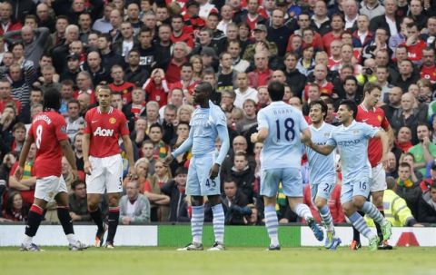 Manchester City's Mario Balotelli, centre, celebrates after scoring against Manchester United during their English Premier League soccer match at Old Trafford Stadium, Manchester, England, Sunday Oct. 23, 2011. (AP Photo/Jon Super)