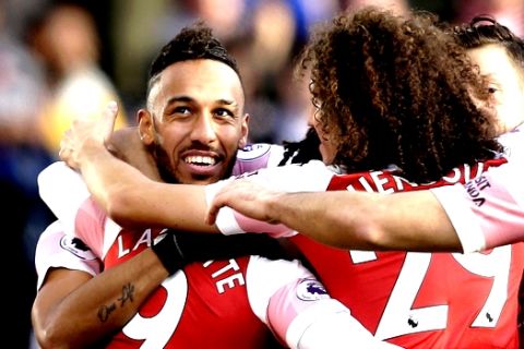 Arsenal's Pierre-Emerick Aubameyang, left, celebrate with teammates after scoring his side's second goal during the English Premier League soccer match between Arsenal and Burnley at the Emirates Stadium in London, Saturday, Dec. 22, 2018. (AP Photo/Tim Ireland)