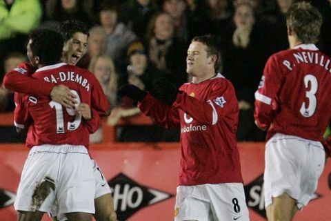 Manchester United's Cristiano Ronaldo, second left, is congratulated by team mate Eric Djemba-Djemba after scoring against Exeter during their FA Cup third round replay soccer match at Exeter's St James' Park ground in Exeter, England, Wednesday, Jan. 19, 2005.  (AP Photo/Alastair Grant) 