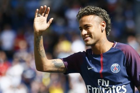 Brazilian soccer star Neymar waves to fans at the Parc des Princes stadium in Paris, Saturday, Aug. 5, 2017, during his official presentation to fans ahead of Paris Saint-Germain's season opening match against Amiens. Neymar would not play in the club's season opener as the French football league did not receive the player's international transfer certificate before Friday's night deadline. The Brazil star became the most expensive player in soccer history after completing his blockbuster transfer from Barcelona for 222 million euros ($262 million) on Thursday. (AP Photo/Francois Mori)