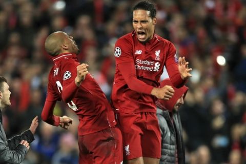 Liverpool's Fabinho, left, and Virgil van Dijk celebrate after the Champions League Semi Final, second leg soccer match between Liverpool and Barcelona at Anfield, Liverpool, England, Tuesday, May 7, 2019. Liverpool won the match 4-0 to overturn a three-goal deficit to win 4-3 on aggregate. (Peter Byrne/PA via AP)