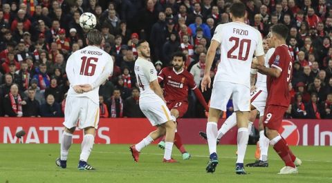 Liverpool's Mohamed Salah, center, scores the opening goal against Roma during their Champions League, Semifinal first leg soccer match at Anfield, Liverpool, England, Tuesday April 24, 2018. (Peter Byrne/PA via AP)