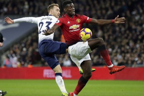 Tottenham's Christian Eriksen fights for the ball with Manchester United's Paul Pogba, right, during the English Premier League soccer match between Tottenham Hotspur and Manchester United at Wembley stadium in London, England, Sunday, Jan. 13, 2019. (AP Photo/Tim Ireland)