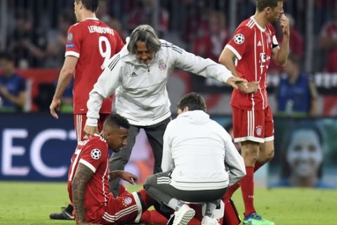 Bayern's Jerome Boateng is attend to by team doctor Hans-Wilhelm Mueller-Wohlfahrt during the soccer Champions League first leg semifinal soccer match between FC Bayern Munich and Real Madrid in Munich, southern Germany, Wednesday, April 25, 2018. (Sven Hoppe/dpa via AP)