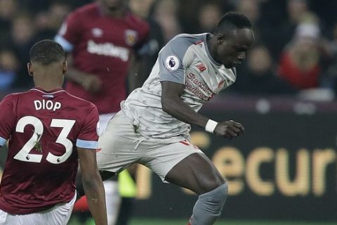 West Ham's Issa Diop, left, and Liverpool's Naby Keita challenge for the ball during the English Premier League soccer match between West Ham United and Liverpool at the London Stadium in London, Monday, Feb. 4, 2019.(AP Photo/Kirsty Wigglesworth)