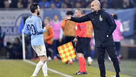 Manchester City coach Pep Guardiola, right, gives instructions from the side line to his player Bernardo Silva during the first leg, round of sixteen, Champions League soccer match between Schalke 04 and Manchester City at Veltins Arena in Gelsenkirchen, Germany, Wednesday Feb. 20, 2019. (AP Photo/Martin Meissner)
