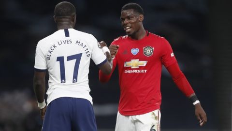 Tottenham's Moussa Sissoko and Manchester United's Paul Pogba greet each other at the end of the English Premier League soccer match between Tottenham Hotspur and Manchester United at Tottenham Hotspur Stadium in London, England, Friday, June 19, 2020. (AP Photo/Shaun Botterill, Pool)