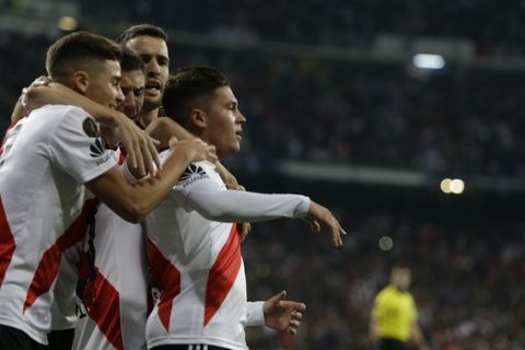 Juan Quintero of Argentina's River Plate celebrates with his teammates after scoring River's second goal in overtime against Argentina's Boca Juniors during the Copa Libertadores final soccer match at the Santiago Bernabeu stadium in Madrid, Spain, Sunday, Dec. 9, 2018. (AP Photo/Thanassis Stavrakis)
