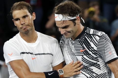 FILE - In this Jan. 29, 2017, file photo, Switzerland's Roger Federer, right, is congratulated by Spain's Rafael Nadal after winning the men's singles final at the Australian Open tennis championships in Melbourne, Australia. Federer and Nadal have never met at the U.S. Open, where play begins Monday, Aug. 28, 2017, and if they face each other this year in New York, it could only be in a semifinal. (AP Photo/Dita Alangkara, File )