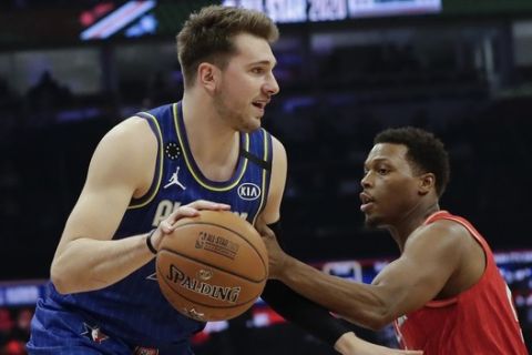 Luka Doncic of the Dallas Mavericks drives past Kyle Lowry of the Toronto Raptors during the first half of the NBA All-Star basketball game Sunday, Feb. 16, 2020, in Chicago. (AP Photo/Nam Huh)
