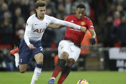 Tottenham's Dele Alli, left, and Manchester United's Anthony Martial vie for the ball during the English Premier League soccer match between Tottenham Hotspur and Manchester United at Wembley stadium in London, England, Sunday, Jan. 13, 2019. (AP Photo/Matt Dunham)