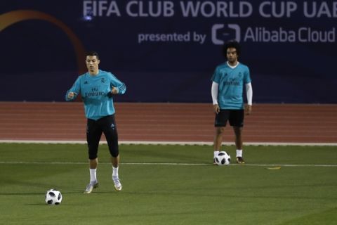 Real Madrid's Cristiano Ronaldo, left, and Marcelo train during a training session in Abu Dhabi, United Arab Emirates, Monday, Dec. 11, 2017. Real Madrid will play against Al Jazira Club on Wednesday in a Club World Cup semifinal soccer match. (AP Photo/Hassan Ammar)