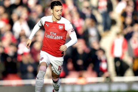Arsenal's Mesut Ozil challenge for the ball during the English Premier League soccer match between Arsenal and Burnley at the Emirates Stadium in London, Saturday, Dec. 22, 2018. (AP Photo/Tim Ireland)