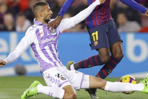FC Barcelona's Dembele, right, duels for the ball with Valladolid's Joaquin Fernandez during the Spanish La Liga soccer match between FC Barcelona and Valladolid at the Camp Nou stadium in Barcelona, Spain, Saturday, Feb. 16, 2019. (AP Photo/Manu Fernandez)