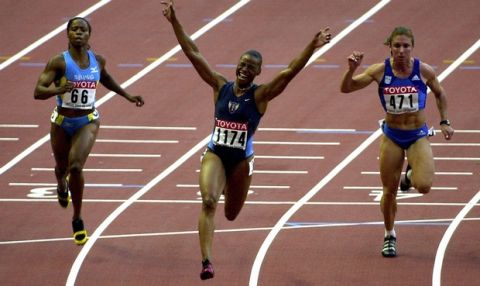 Kelli White (C) of the US celebrates after winning the women's 100m final, 24 August 2003 during the 9th IAAF World Athletics Championships at the Stade de France in Saint-Denis outside of Paris. Ekaterini Thanou of Greece (C) was fifth and Chandra Sturrup of the Bahamas (L) fourth.