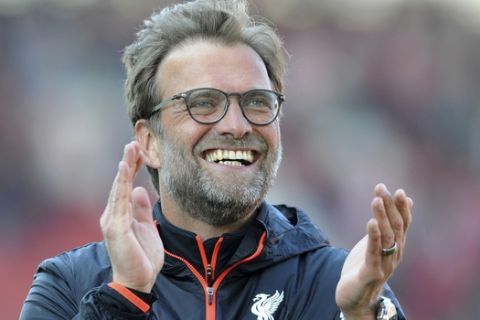 Liverpool manager Juergen Klopp applauds fans after Liverpool beat Stoke 2-1 during the English Premier League soccer match between Stoke City and Chelsea at the Britannia Stadium, Stoke on Trent, England, Saturday, April 8, 2017. (AP Photo/Rui Vieira)