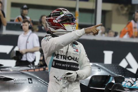 Mercedes driver Lewis Hamilton of Britain celebrates pole position during the qualifying session at the Yas Marina racetrack in Abu Dhabi, United Arab Emirates, Saturday, Nov. 30, 2019. The Emirates Formula One Grand Prix will take place on Sunday. (AP Photo/Hassan Ammar)