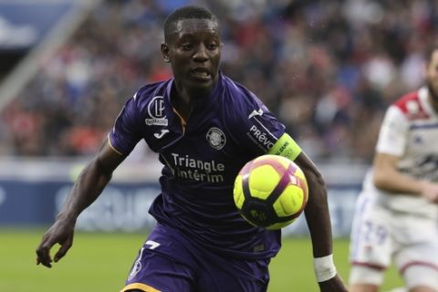 Toulouse's Max Gradel challenges for the ball during the French League One soccer match between Lyon and Toulouse, in Decines, near Lyon, central France, Sunday, March 3, 2019. (AP Photo/Laurent Cipriani)