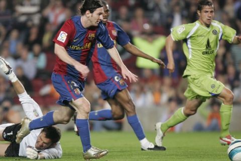 Barcelona forward Lionel Messi, second left, passes goalkeeper Luis Garcia, left, on his way to scoring from a narrow angle in the 29th minute at the Camp Nou stadium in Barcelona, Spain, Wednesday, April 18, 2007. Messi has drawn further comparisons with Diego Maradona by scoring a near replica of one of the former Argentina captain's most famous goals. Messi emulated Maradona's winner against England in the 1986 World Cup quarterfinals in scoring Barcelona's second goal in a 5-2 win over Getafe in the Copa del Rey semifinals. (AP Photos/Manu Fernandez)