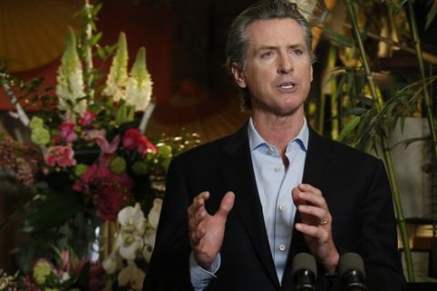 Gov. Gavin Newsom discusses the reopening of businesses during a news conference at Twiggs Floral Design Gallery in Sacramento, Calif., Friday, May 8, 2020. Newsom spoke about his administration's guidance allowing retailers, including flower shops, to begin opening Friday with restrictions like curbside pickup. (AP Photo/Rich Pedroncelli, Pool)